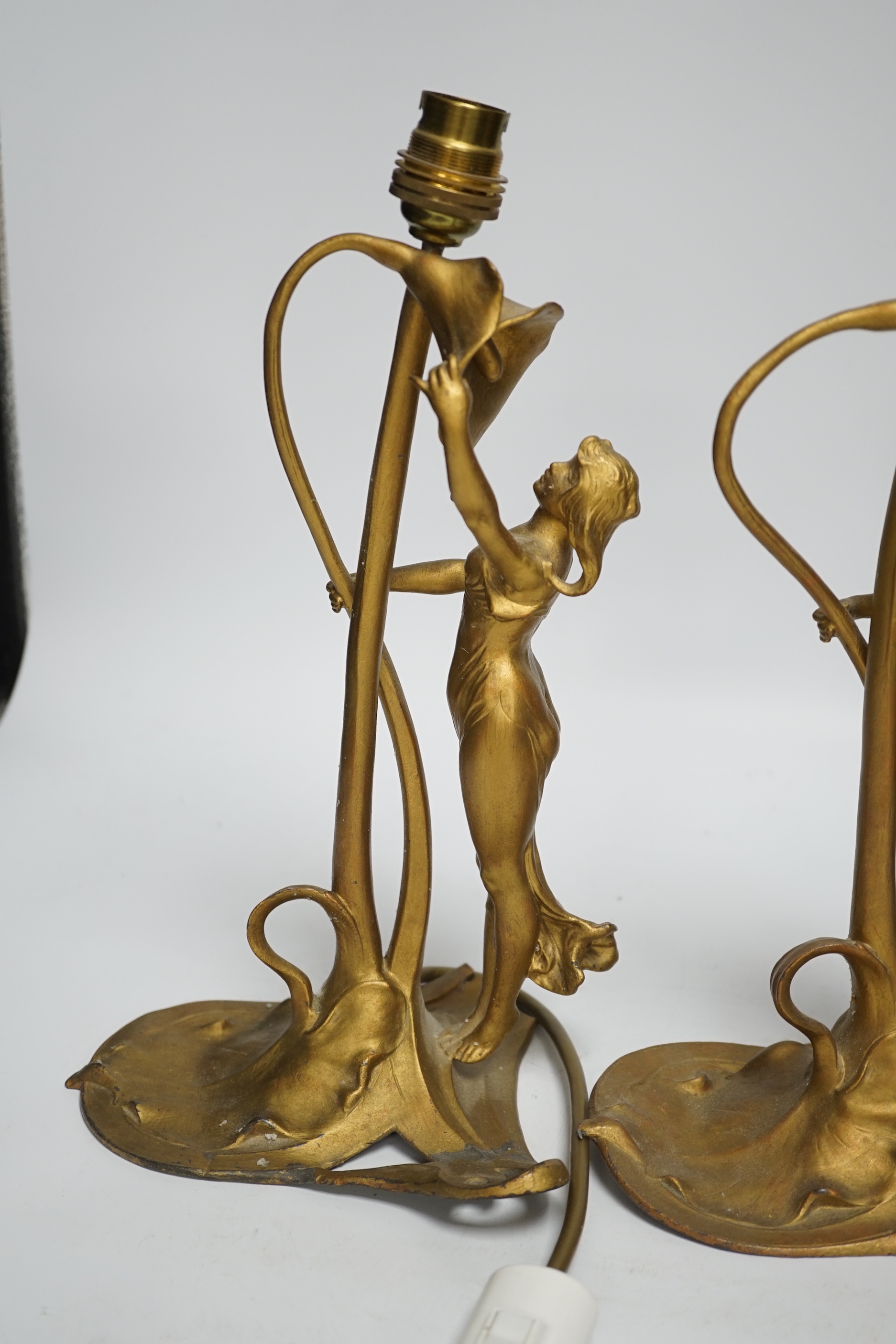 A pair of Christopher Wray, Art Nouveau style lily and figural gilt metal table lamps, 26cm high